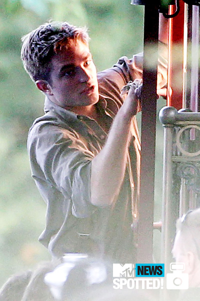  Robert Pattinson climbs aboard a train whilst filming his latest movie, &quot;Water For Elephants,&quot; on June 9. Photo by PacificCoastNews.com