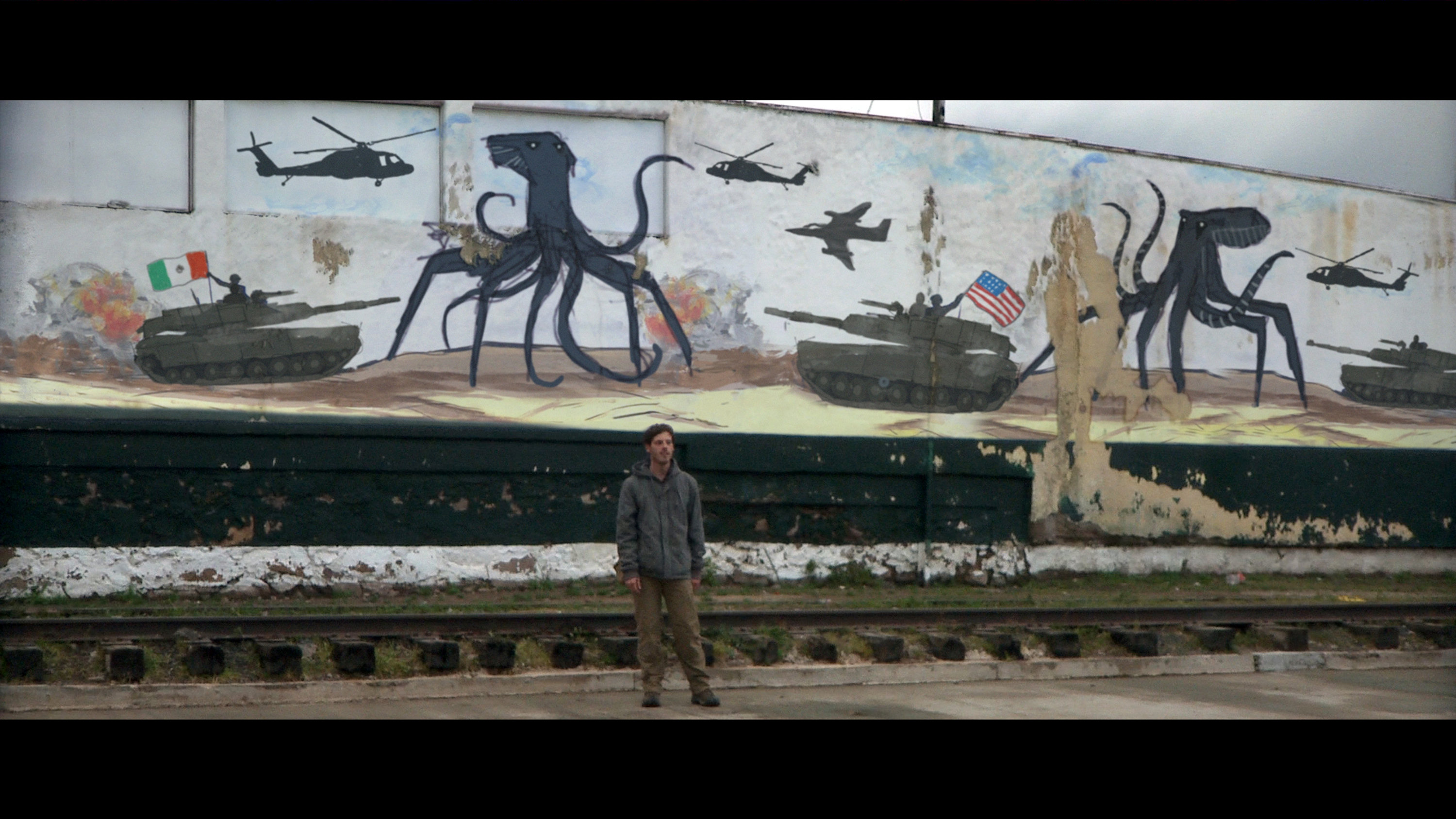  The mural in the background depicts Mexico and US forces battling the alien creatures.